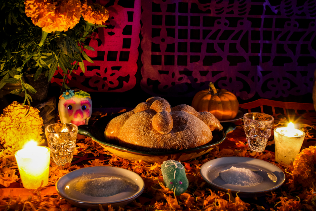 A traditional ofrenda shown with yellow marigold flowers